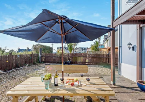 The patio, alfresco dining area & enclosed garden at Ol Tywydd, Broad Haven