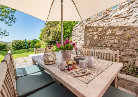 The patio & alfresco dining area at Orlandon Farm Cottage, St Brides