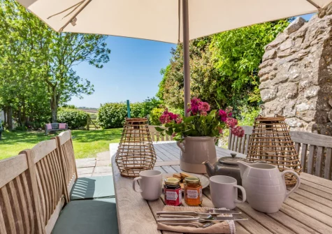 The patio & alfresco dining area at Orlandon Farm Cottage, St Brides