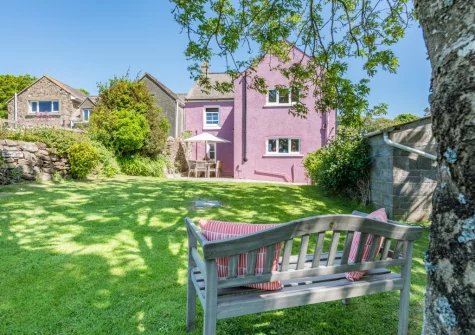 The patio, alfresco dining area & enclosed lawned garden at Orlandon Farm Cottage, St Brides
