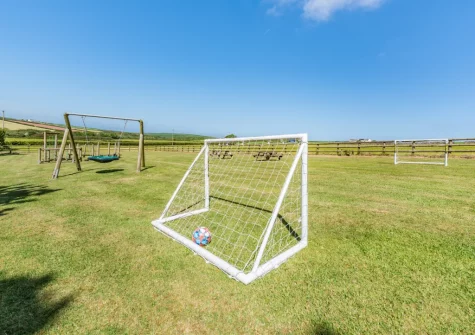 The shared gated children's play area at Orlandon Farm Cottage, St Brides
