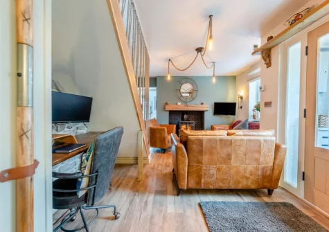 The living room, with dedicated workspace, at Oystercatcher Cottage, Llangwm