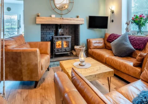 Oystercatcher Cottage, Llangwm is a characterful 250-year-old fisherman's cottage beside the Cleddau River, featuring a private hot tub with stunning water views, cosy wood burner, spacious living areas, and the quirky charm of a historic home.