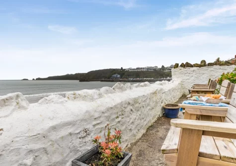 The shared lawn & outdoor sitting area, with direct access down to the beach, at Penllanw, Saundersfoot