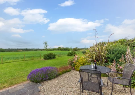 The patio, outdoor sitting area & shared lawned garden at Primrose Cottage, Haverfordwest