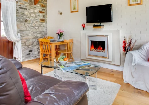 Primrose Cottage, Haverfordwest is a charming single-storey barn conversion in peaceful Pembrokeshire countryside, featuring exposed beams, contemporary interiors, a south-facing patio with rural views, and easy access to stunning coastal beaches.