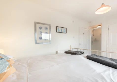Bedroom #1 & en-suite shower room at Pufflings, Broad Haven