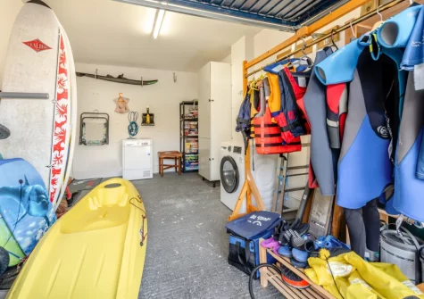 The garage, with a selection of kayaks, surfboards & wetsuits for guest to use, at Pufflings, Broad Haven