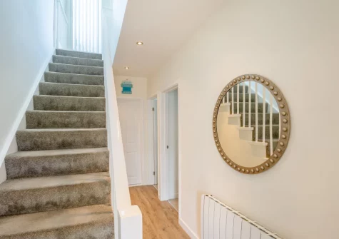 The hallway & stairs up to the first floor at Sea Breeze, 40 Cae Du, Abersoch
