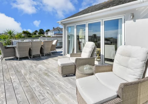 The expansive wrap-around sundeck, alfresco dining & outdoor sitting area at Seabreeze, Abersoch