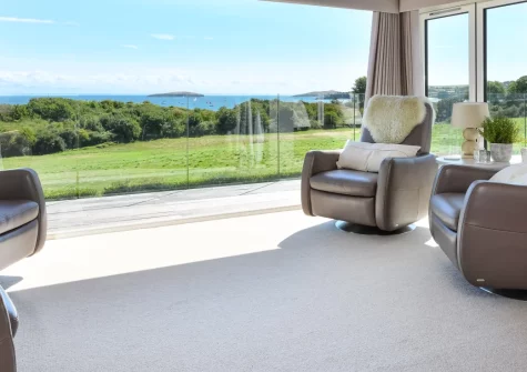 Seabreeze, Abersoch is an impressive five-bedroom retreat on the stunning Llŷn Peninsula, featuring spectacular coastal views from a wrap-around sundeck, sumptuous interiors with four en-suite king-size bedrooms, and Abersoch's golden beach nearby.