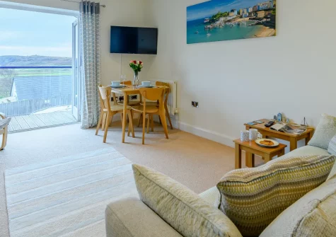 Seabreeze, Penally is a charming first-floor apartment in a peaceful coastal village, boasting panoramic sea views over Tenby Golf Course and Caldey Island, with a private balcony, dedicated parking, and Tenby's stunning beaches moments away.