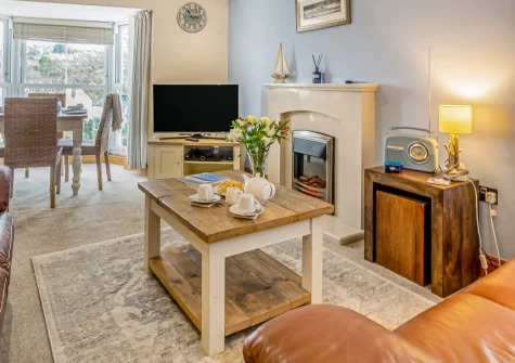 Seacove, Saundersfoot is a charming two-bedroom maisonette in the heart of this seaside village, featuring stunning bay views towards the golden sands and sea beyond, light-filled contemporary interiors, and the coast path on your doorstep.