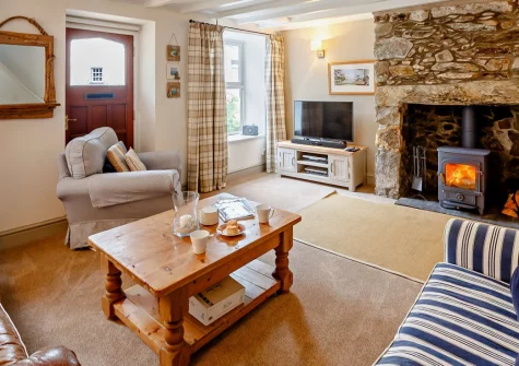 Siop Newydd, Llanengan is a characterful stone cottage in the heart of the Llŷn Peninsula, featuring exposed stone walls, a cosy wood burner, and a peaceful garden with mountain views, moments from Hell's Mouth beach and Abersoch's golden sands.