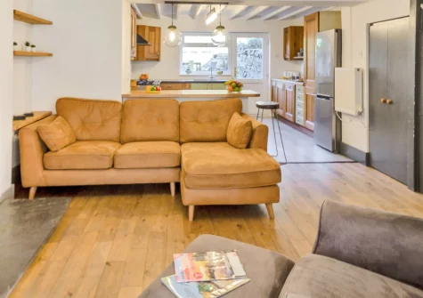 Slate Trail Retreat, Cwm Penmachno is a riverside stone cottage sleeping six across three bedrooms in Eryri National Park, with a mountain-view garden, cosy wood burner, and the Slate Trail passing right by the door for keen hikers and cyclists.