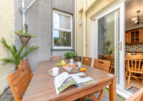The enclosed courtyard & alfresco dining area at Somerville, Tenby