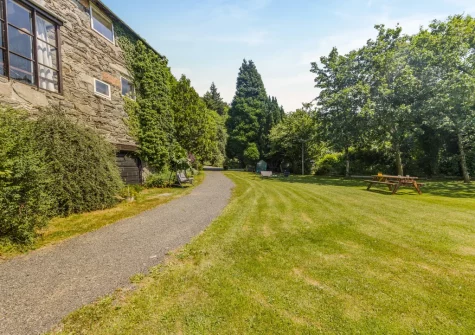 The spacious enclosed lawned garden at Sounds of the Brook, Llanelltyd