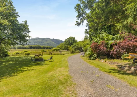 The spacious enclosed lawned garden at Sounds of the Brook, Llanelltyd