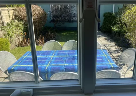 Step out into the sunny rear garden, with patio & alfresco dining area, at South Seas, Tenby