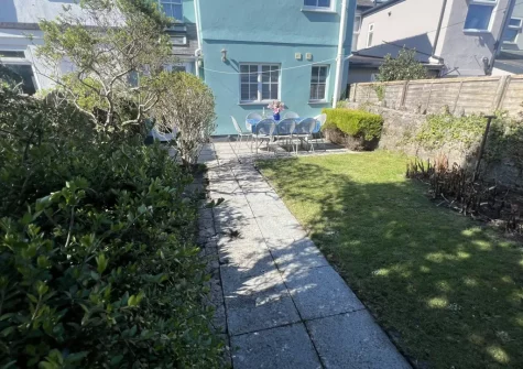 The sunny rear garden with patio & alfresco dining area at South Seas, Tenby