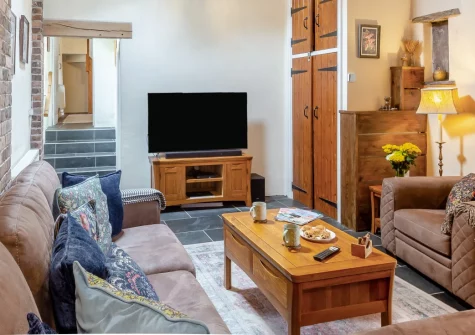 Tal-Y-Waun, Capel Curig is a charming 300-year-old stone cottage tucked into the Ogwen Valley, featuring exposed beams, a cosy wood burner, mountain views, and an enclosed garden perfect for alfresco dining after a day exploring Eryri's peaks.