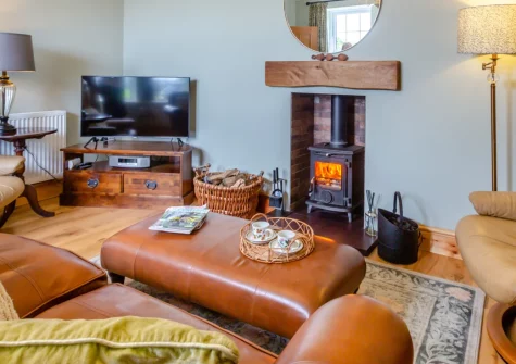 Talafon, Pencaenewydd is a charming two-bedroom cottage nestled near Eryri Snowdonia, with a pretty enclosed garden, cosy wood burner, private parking and easy access to Llŷn Peninsula beaches, castles and quarries, ideal for family holidays.