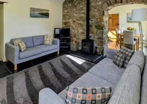Tan Y Bryn Y Beudy, Cwm-Yr-Eglwys is a beautifully renovated cottage set in peaceful farmhouse grounds, featuring contemporary interiors with wood burner, shared gardens with wildlife pond, and stunning coastal walks to hidden Pembrokeshire beaches.