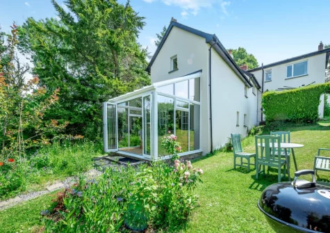The lawned garden, barbecue & alfresco dining area at Tan y Castell Cottage, Llan-mill