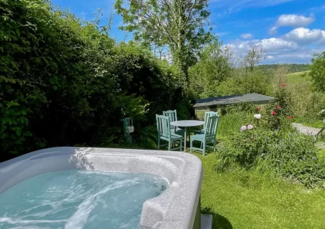 The hot tub & lawned gaden at Tan y Castell Cottage, Llan-mill