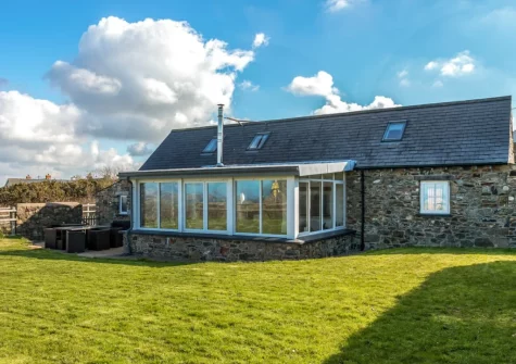 The patio, alfresco dining area & enclosed lawned garden at Temple Barn, Square and Compass