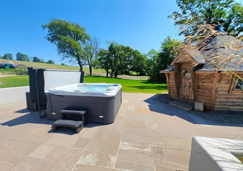 The patio, hot tub, enclosed barbecue hut & large lawned garden at The Barn at Arnold's Hill Farm, Slebech