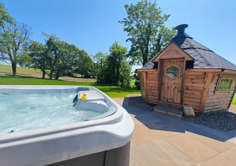 The patio, hot tub, enclosed barbecue hut & large lawned garden at The Barn at Arnold's Hill Farm, Slebech