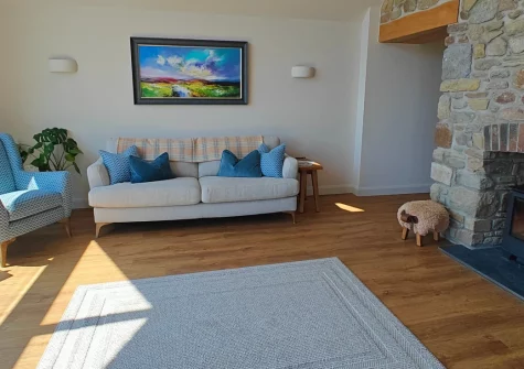 The Barn at Arnold's Hill Farm, Slebech is a stunning barn conversion set amid Pembrokeshire's countryside, featuring a private hot tub, unique BBQ hut, panoramic rural views, and beautifully appointed interiors with exposed beams and wood burner.