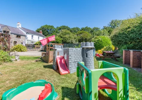 The shared children's play , barbecue & alfresco dining area at The Barn, Haverfordwest
