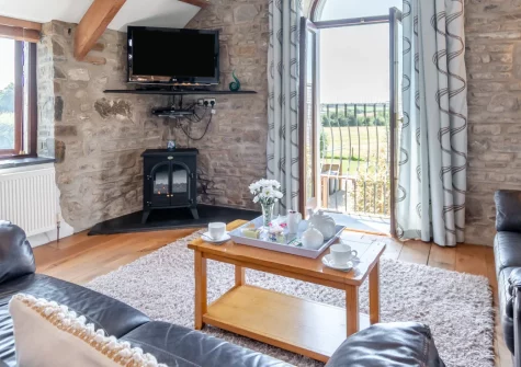 The Barn, Haverfordwest is a beautifully converted two-bedroom countryside retreat with exposed beams and vaulted ceilings, featuring a private garden, shared outdoor spaces, and easy access to Broad Haven's magnificent Atlantic beaches.