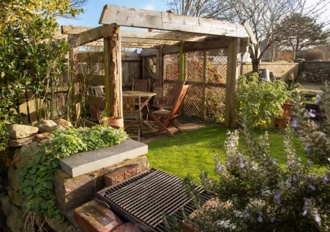The barbecue, alfresco dining & enclosed lawned garden at The Croft, LLanrhian