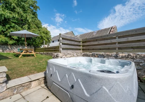 The patio, hot tub, alfresco dining area & garden at The Granary, St Florence