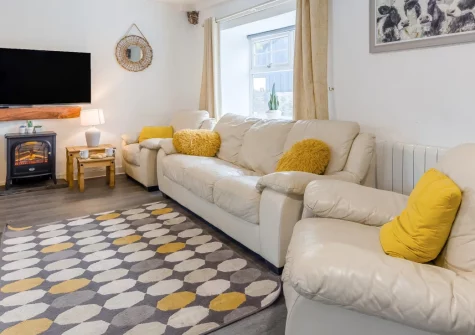 The Granary, St Florence is a beautiful stone cottage in peaceful Pembrokeshire countryside, featuring a private hot tub, heated indoor pool access, and spacious family living, with Tenby's sandy beaches and locl attractions close by.