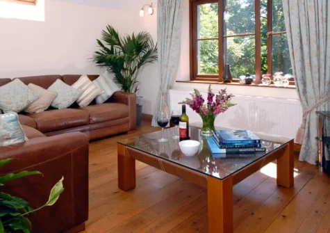 The Hayloft, Broad Haven is a stylish barn conversion surrounded by 107 acres of private woodland near to golden Broad Haven beach, featuring contemporary interiors, a games shed with pickleball court, and tranquil countryside views.
