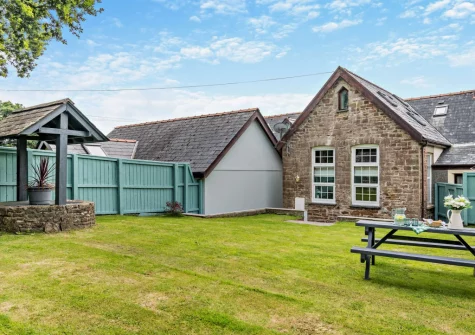 The enclosed rear south-facing garden & alfresco dining area at The Old School Hall, Loveston