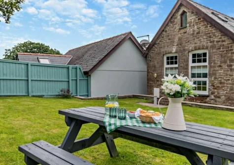 The enclosed rear south-facing garden & alfresco dining area at The Old School Hall, Loveston