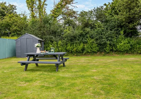 The enclosed rear south-facing garden & alfresco dining area at The Old School Hall, Loveston
