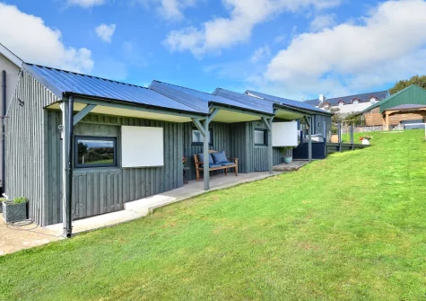 The terrace, outdoor sitting area & lawned garden at The Stables, Abererch