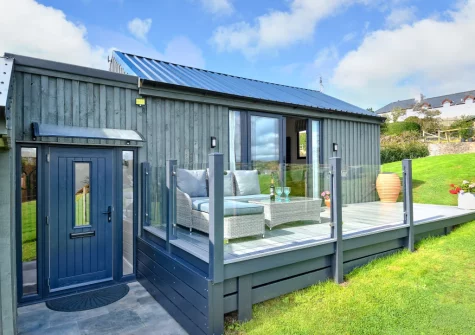 The decked terrace, outdoor sitting area & lawned garden at The Stables, Abererch