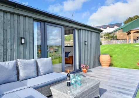 The decked terrace, outdoor sitting area & lawned garden at The Stables, Abererch