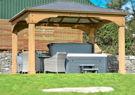 The alfresco dining area, hot tub & lawned garden at The Stables, Abererch