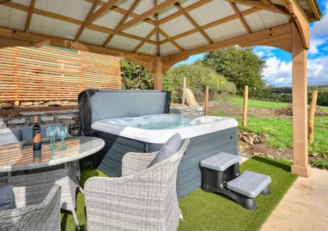 The alfresco dining area & hot tub at The Stables, Abererch