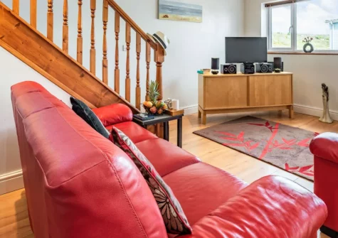 Tickled Pink, Freshwater East is a bright, spacious beach house sleeping six plus a baby, with a sea-view balcony, two sunny verandas and parking, just 300 metres from the golden sand in Pembrokeshire Coast National Park, ideal for families.
