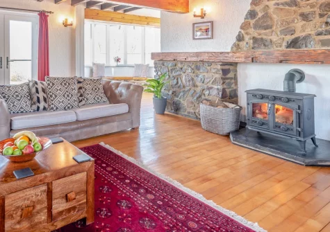 Trebrowen, Angle is a spectacular ten-bedroom retreat on Pembrokeshire's coast, featuring a heated pool, private hot tub, outdoor bar with pizza oven, games room and multiple lounges, perfect for group celebrations in stunning surroundings.