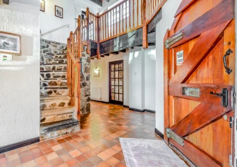 The entrance hallway & stairs up to the first floor at Trebrowen, Angle